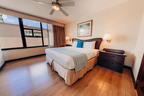 a hotel room with a large bed and a window at La Quinta by Wyndham Quito in Quito
