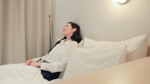 Postel nebo postele na pokoji v ubytování Aank Hotel Osan
