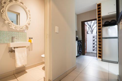 a bathroom with a sink and a mirror at Avemore Mareba Court No 9 in Stellenbosch