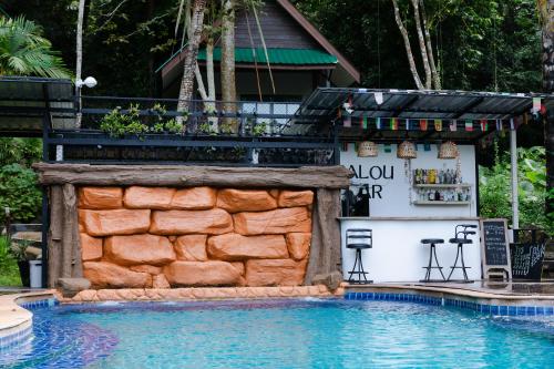 a bar next to a pool at a resort at The Vatika Resort and Spa in Ao Nang Beach