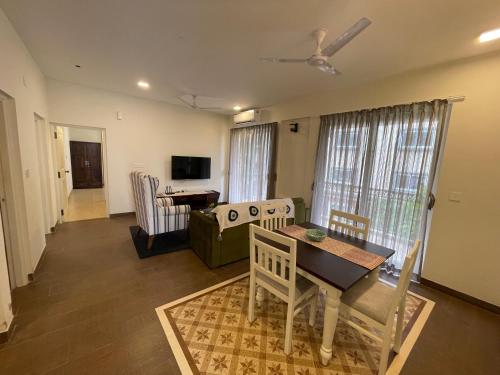 a living room with a table and a couch at 2 BHK Retreat in Sierra Assagao in Assagao