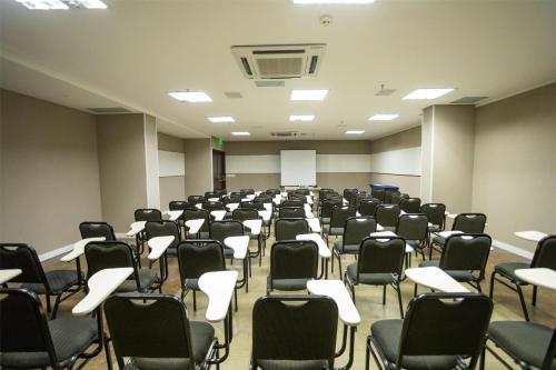 an empty room with desks and chairs in it at Hilton Garden Inn Maceio in Maceió