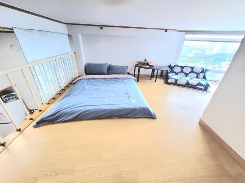 a bed in the middle of a room at Like U Residence in Goyang