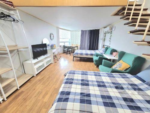 a room with a bed and a living room at Like U Residence in Goyang