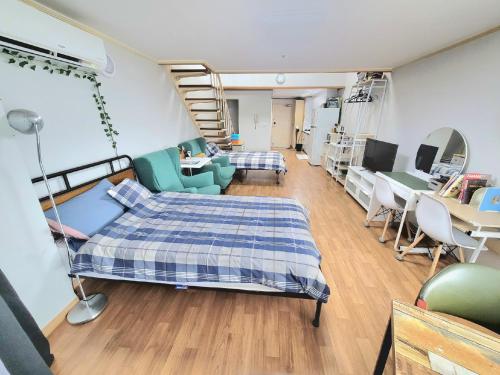 a bedroom with a bed and a living room at Like U Residence in Goyang