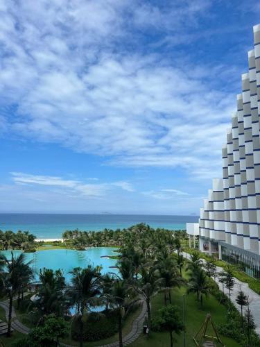a view of a resort with a pool and palm trees at THE SEA at THE ARINA CAM RANH in Thôn Hò Ða