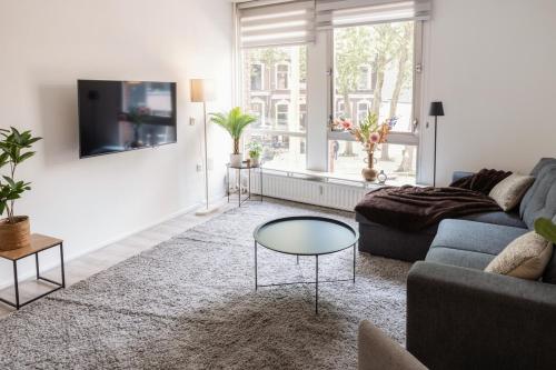 a living room with a couch and a table at 4p-home at best Spot in town near poppodium 013 in Tilburg