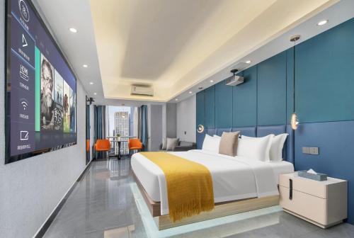 a bedroom with a large bed and a blue wall at Dori1993 Hotel in Changsha