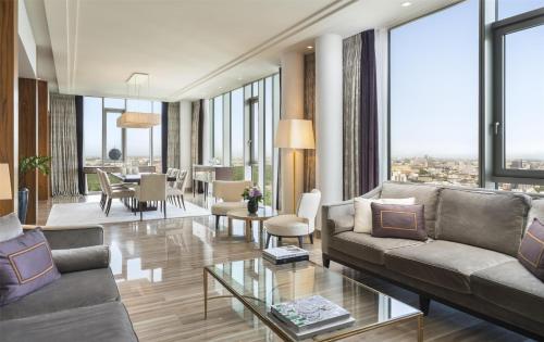 a living room with a couch and a table at Waldorf Astoria Berlin in Berlin