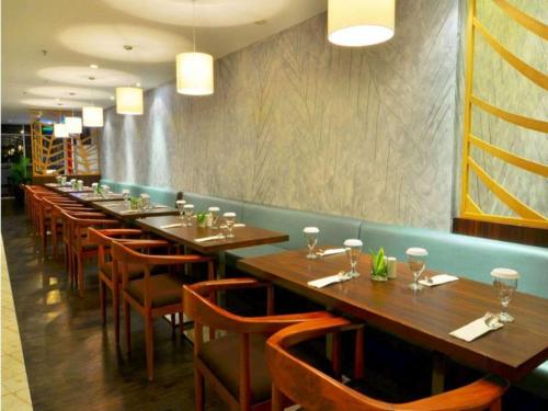 a row of tables and chairs in a restaurant at Bogor Valley Hotel in Bogor