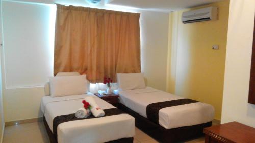 Ένα ή περισσότερα κρεβάτια σε δωμάτιο στο Sun Inns Hotel Kuala Selangor