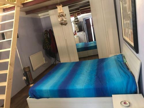 a bedroom with a blue bed and a ladder at Il Borgo del Ghiro in Irola