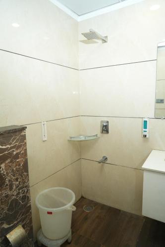 a bathroom with a toilet and a sink and a mirror at Naina Staycation Udaipur in Udaipur