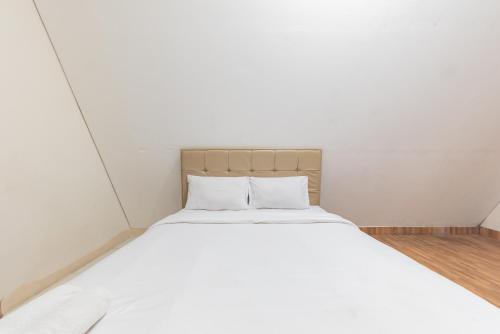 Ένα ή περισσότερα κρεβάτια σε δωμάτιο στο RedDoorz Premium @ Griya Inkoppabri Cisarua Puncak