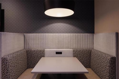 a white table in a room with a light at Home2 Suites By Hilton Kittery in Kittery