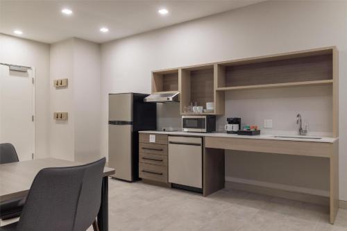 a kitchen with a sink and a counter top at Home2 Suites By Hilton Kittery in Kittery