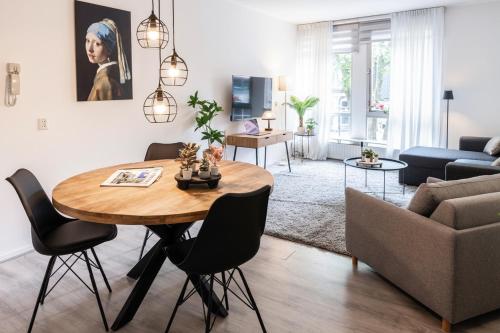 a living room with a table and a couch at 4p-home at best Spot in town near poppodium 013 in Tilburg