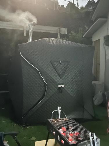 a large grill in a yard with a table at FLORAhouse in Oita