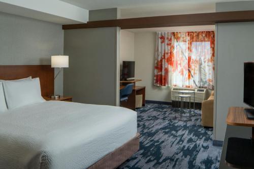 a hotel room with a bed and a television at Fairfield Inn & Suites by Marriott Atmore in Atmore