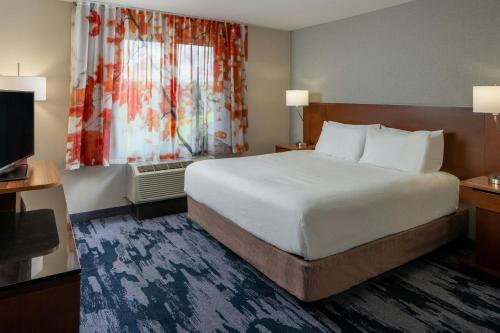 a hotel room with a large bed and a window at Fairfield Inn & Suites by Marriott Atmore in Atmore
