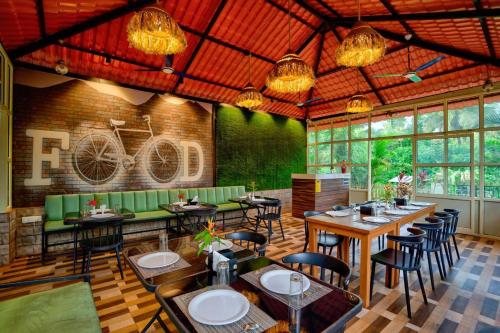 a restaurant with tables and chairs and a bike on the wall at Maya resort in Jāmb