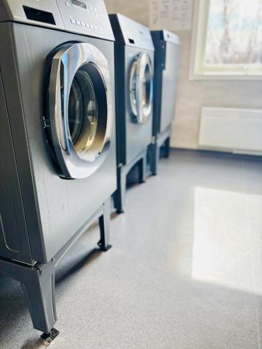 a row of washing machines in a laundry room at Frost Longstay Lakeside in Kiruna