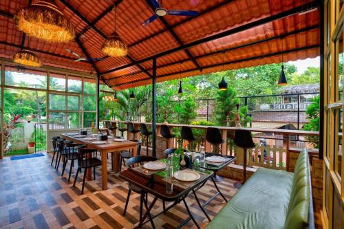 a restaurant with tables and chairs and a balcony at Maya resort in Jāmb