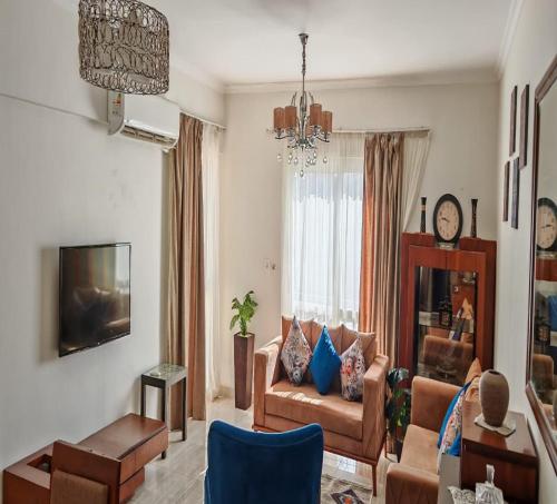 a living room with a couch and a tv at Al Rehab city, Avenue Mall group129 bulding7 5th, CASA MIA in New cairo