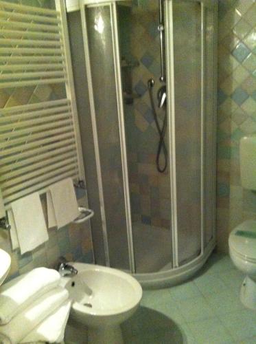 a bathroom with a shower and a sink and a toilet at Hotel Villa Tiziana in Venice-Lido