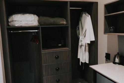 a bathroom with a closet with a sink at The Rasmus in Pretoria