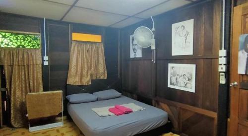 a bedroom with two beds in a room with blue walls at MyDesaStay in Sekincan