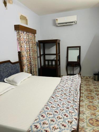 a bedroom with a bed and a mirror at House of Amer in Jaipur