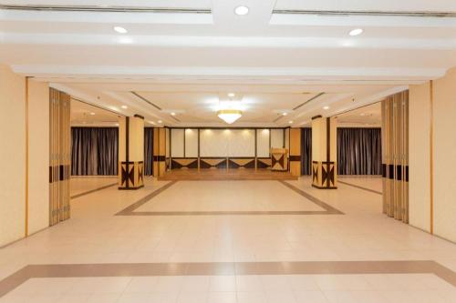 a large hall with a stage in the middle at Pelican Hotel in Batu Pahat