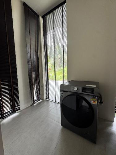 a television sitting in a living room with a window at Siam Residence - Modern Villa with a Private Pool in Koh Phangan