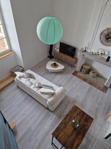 a living room with a couch and a table at T2 moderne hypercentre - vue imprenable sur la ville in Auch