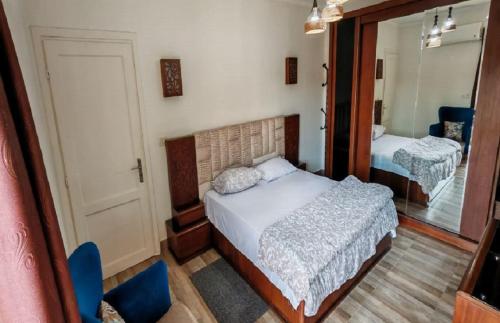 a small bedroom with a bed and a mirror at Al Rehab city, Avenue Mall group129 bulding7 5th, CASA MIA in New cairo