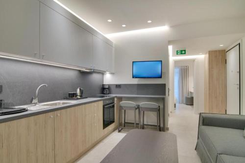 a kitchen with a sink and a living room at ''Γειτονιά της γνώσης'' Luxury Apartments Ioannina in Ioannina
