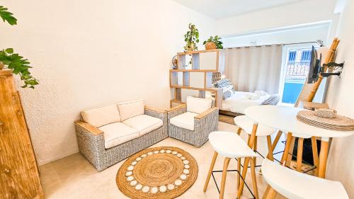 a living room with a table and chairs at Bali Beach Flats, Muizenberg in Cape Town