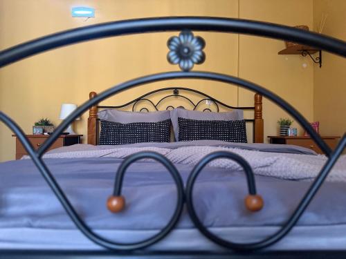 a metal bed with purple sheets and pillows at Lidori Mani in Akhíllion