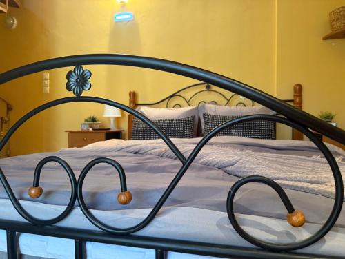 a bedroom with a bed with a metal frame at Lidori Mani in Akhíllion