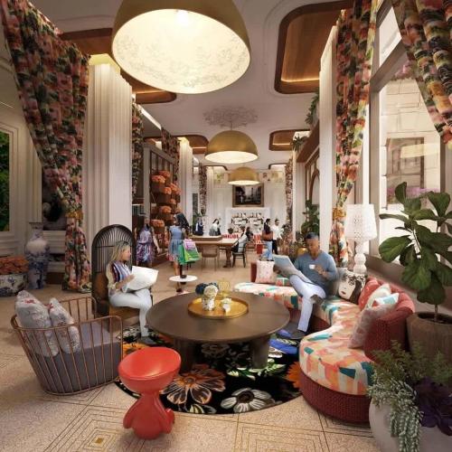 a lobby with people sitting on couches and tables at Sky Central #8 CozySuites in Cincinnati