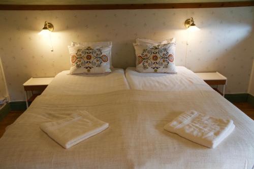 two towels are sitting on a white bed at THE LODGE Torsby in Torsby