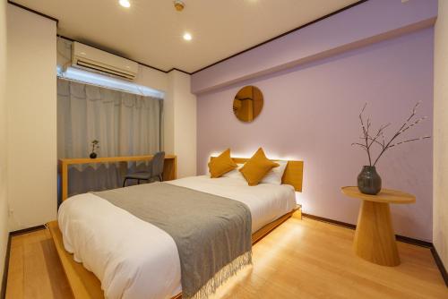 a bedroom with a large bed and a table at Nagoya 12min Legoland 25min 3BR 4Beds Sofa 9ppl in Nagoya