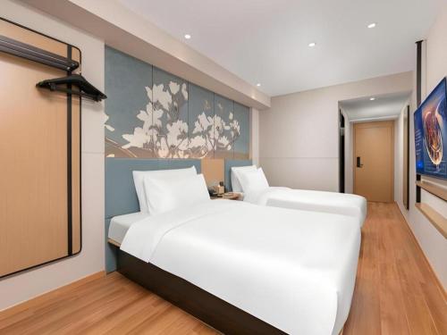 Ένα ή περισσότερα κρεβάτια σε δωμάτιο στο Magnotel Classic Shenyang General Hospital of Northern Theater Command