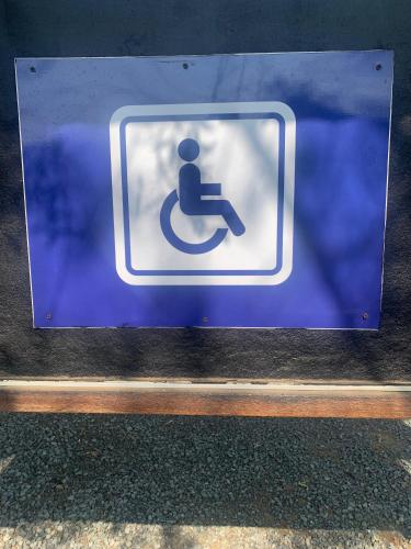 a blue sign with a person sitting on a toilet at B and B at Bloem in Bloemfontein
