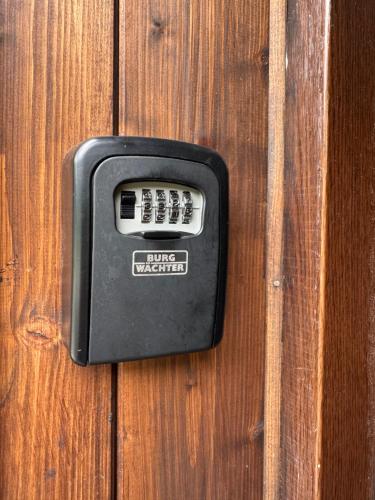 a black object sitting on a wooden table at Ubytování za babku s infrasaunou in Jeseník