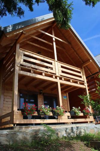 a house with potted plants on the front of it at LAna in Šipovo