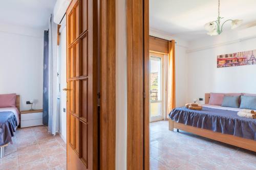 a bedroom with a bed and a window and a door at Sa omu de sa palgia in Jerzu