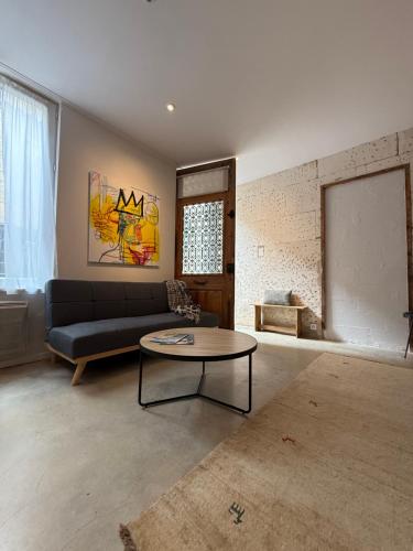 a living room with a couch and a table at Studio du Cherche Midi in Jarnac