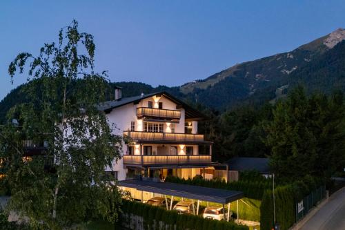 a large house in the middle of a mountain at Bergkranz Apartments in Seefeld in Tirol